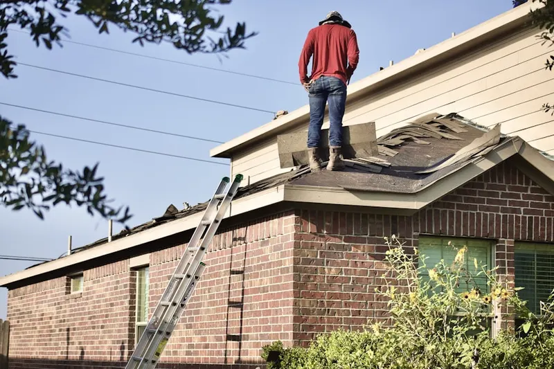 Professional roofer working on a residential roof in North Branford